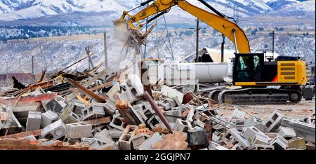 Heavy equipment being used to tear tearing down building construction Stock Photo