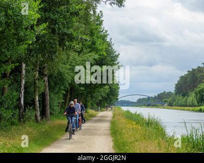 Riverside path with cyclists, branch canal Osnabrück, Osnabrücker Land, Lower Saxony, Germany Stock Photo