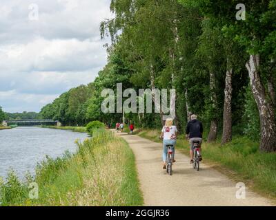 Riverside path with cyclists, branch canal Osnabrück, Osnabrücker Land, Lower Saxony, Germany Stock Photo