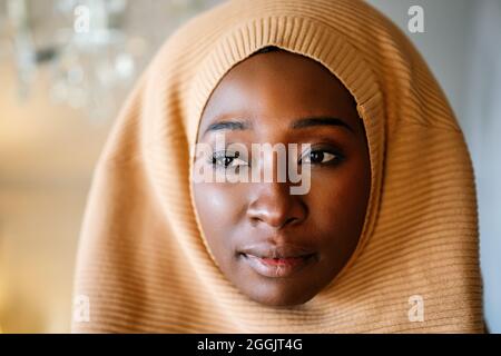 Tranquil portrait of beautiful young black muslim woman wearing hijab Stock Photo