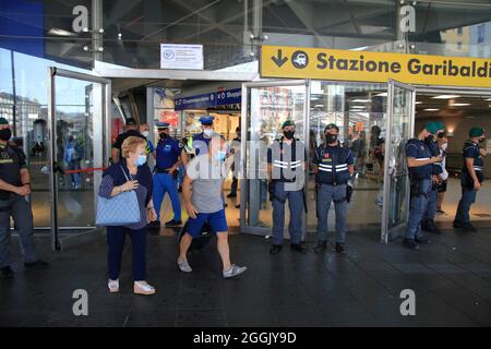 Entry into force of the possession of the green pass (certification of vaccination against covid-19) on long-distance trains. On the instructions of Interior Minister Lamorgese, to avoid protests of no-vax and no-green passes, all major Italian railway stations are manned by a large number of police forces . At the station of Naples closed all the various accesses. One access only for the entrance and one only for the exit from the station. Travelers forced to a long walk from the parking lot to the entrance and exit area. I've seen a lot of police and financial police officers. (Photo by Pas Stock Photo