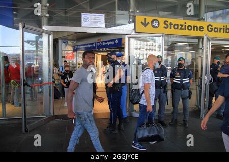 Entry into force of the possession of the green pass (certification of vaccination against covid-19) on long-distance trains. On the instructions of Interior Minister Lamorgese, to avoid protests of no-vax and no-green passes, all major Italian railway stations are manned by a large number of police forces . At the station of Naples closed all the various accesses. One access only for the entrance and one only for the exit from the station. Travelers forced to a long walk from the parking lot to the entrance and exit area. I've seen a lot of police and financial police officers. (Photo by Pas Stock Photo