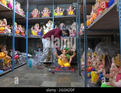 Mumbai, India. 01st Sep, 2021. A man seen making final touches on an idol of Hindu god Ganesh inside a workshop ahead of Ganesh Chaturthi celebration.Ganesh Chaturthi will be celebrated in India from 10th September. Credit: SOPA Images Limited/Alamy Live News Stock Photo