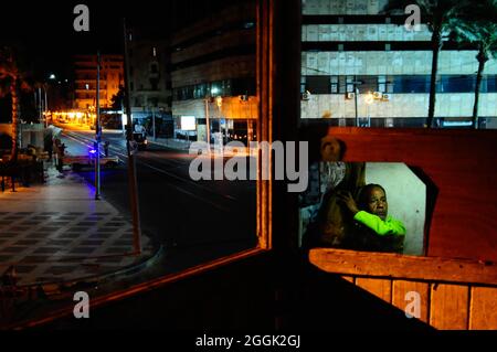 Ezzat, an Egyptian man without a shelter or a home, stays in a police booth in the center of Alexandria during the curfew. Alexandria, Egypt. Stock Photo