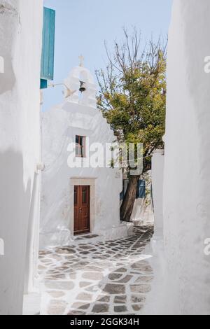 View of a chapel from a narrow street in Hora (also known as Mykonos Town), Mykonos, Greece. Stock Photo