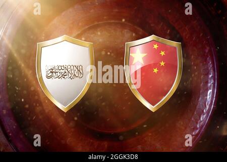 taliban and china flag in golden shield on copper texture background. Stock Photo