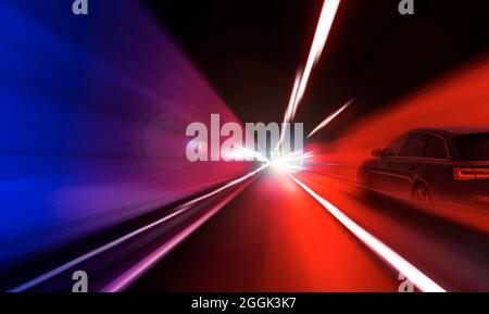 Cars rush through the tunnel in the beams of searchlights. Stock Photo