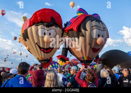 'Boy Balloon' (left) and 'Oons Wiefke' special shape hot air balloons and crowd, Albuquerque International Balloon Fiesta, Albuquerque, New Mexico USA Stock Photo