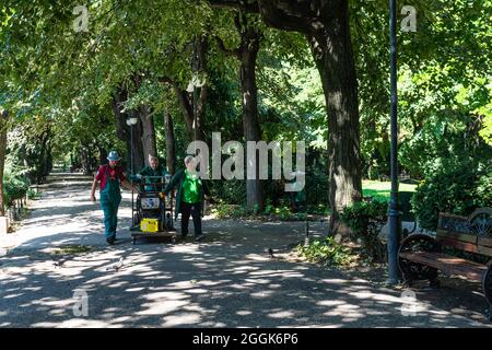 Maintenance of public park and gardens. Municipal workers cleaning public park Cismigiu Gardens in Bucharest, Romania, 2021 Stock Photo