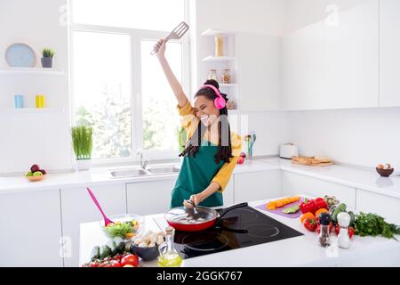 Premium Photo  Cooking utensils. cooking woman in kitchen with frying pan  and wooden spoon. housewife dancing.
