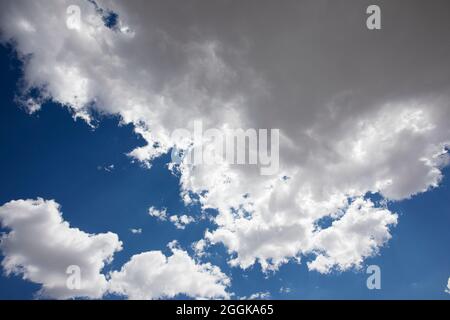 Fluffy white clouds and a deep blue sky. Stock Photo
