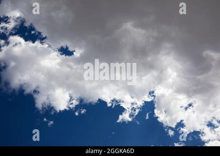 Fluffy white clouds and a deep blue sky. Stock Photo