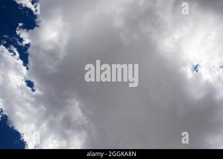 Fluffy white clouds and a deep blue sky. Stock Photo