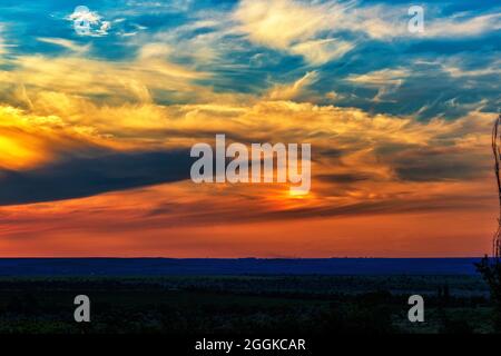 The landscape of a colorful sunset over the plain Stock Photo