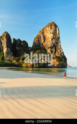 Female jogger on West Rai Leh Beach at sunrise, Rialay Peninsula, Andaman Sea, Krabi, Thailand, Asia Stock Photo