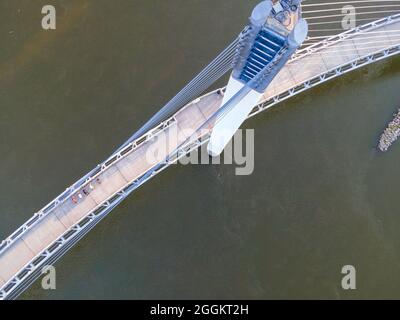 Aerial photograph of the Bob Kerrey Pedestrian Bridge that spans the Missouri River between Council Bluffs, Iowa and Omaha, Nebraska on a beautiful mo Stock Photo