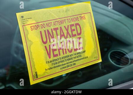 A waring sticker in a car window for being not road taxed Stock Photo