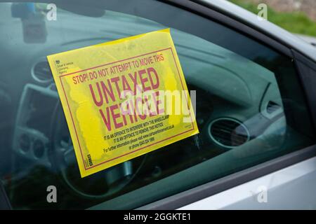 A waring sticker in a car window for being not road taxed Stock Photo