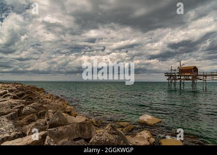 At the foot of the ancient village of Termoli, the Promenade of the Trabucchi winds its way, a portion of the coast from which you have access to the Stock Photo