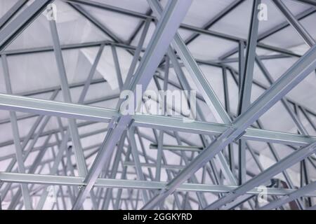 Metallic modern construction of roof overlap of the building closeup Stock Photo