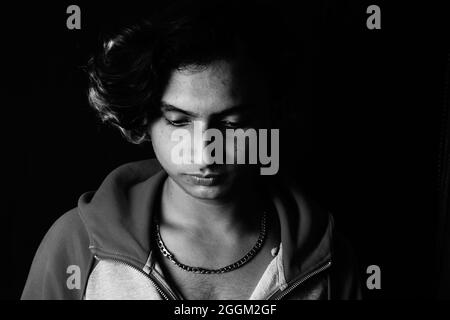 Grayscale shot of a young Indian man's serious face Stock Photo