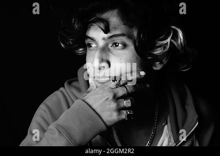 Grayscale shot of a young Indian man's serious face Stock Photo