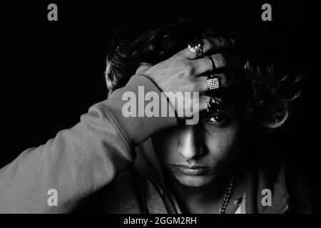 Grayscale shot of a young Indian man's serious face Stock Photo