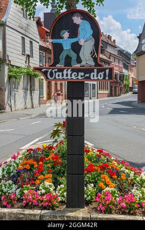 Germany, Bavaria, Miltenberg, signpost to the toilet 'Vatter-do', son shows the father the way. Stock Photo
