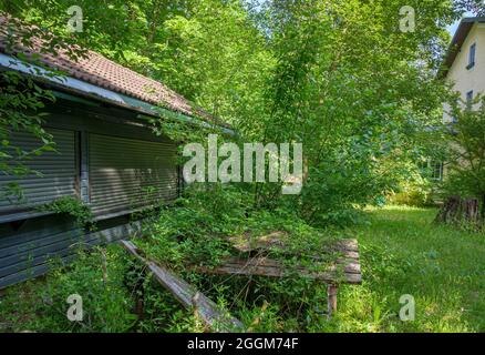 Lost Place, overgrown beer garden with moss-covered seating areas, Gasthof Obermuehltal, Bavaria, Germany, Europe Stock Photo