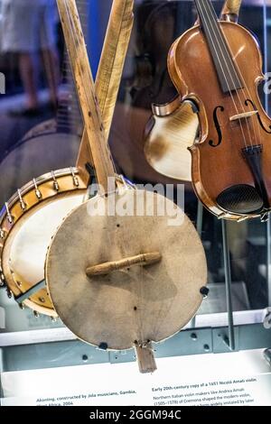 Old banjo and fiddle on display inside the Blue Ridge Music Center on the Blue Ridge Parkway in Galax, Virginia. Stock Photo