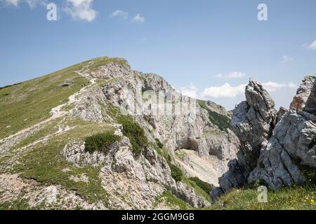 Mountain hikers on the south-facing ascent to the Predigtstuhl (1902 m) on the Rax, Styria, Austria Stock Photo
