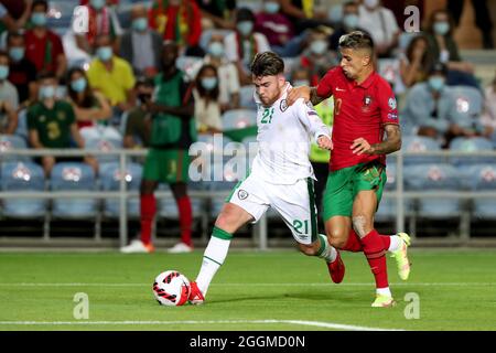 Faro, Portugal. 1st Sep, 2021. Ireland's forward Aaron Connolly (L) vies with Portugal's defender Joao Cancelo during the FIFA World Cup 2022 European qualifying round group A football match in Faro, Portugal, Sept. 1, 2021. Credit: Pedro Fiuza/Xinhua/Alamy Live News Stock Photo