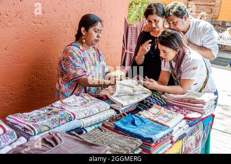 Mexico City Mexican,Hispanic Coyoacan Del Carmen,embroidered clothing,fair trade artisan,vendor stall booth marketplace family looking shopping Stock Photo