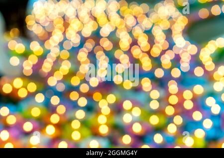 Golden circular blur light bokeh abstract on a blurred blue background. Holiday concept backdrop with twinkling bright shapes.Blinking Christmas Stock Photo