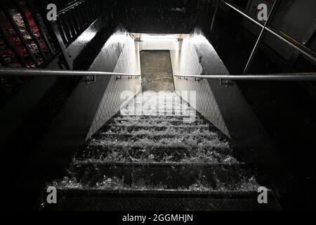 New York City, USA. 01st Sep, 2021. Flood waters cascade down subway steps as remnants of Hurricane Ida brings three inches of rain per hour across the city, in the New York City borough of Queens, NY, September 1, 2021. (Photo by Anthony Behar/Sipa USA) Credit: Sipa USA/Alamy Live News Stock Photo