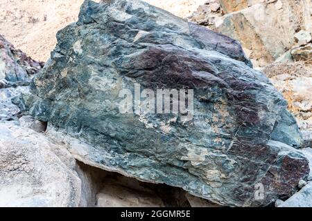 Raw ore of copper, green stones and rocks containing copper in old mining area, Hajar Mountains, United Arab Emirates. Stock Photo