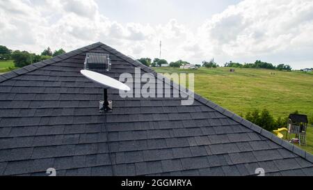 SpaceX Starlink satellite dish mounted on the roof of a rural home. Starlink is an all-new satellite internet constellation. Stock Photo