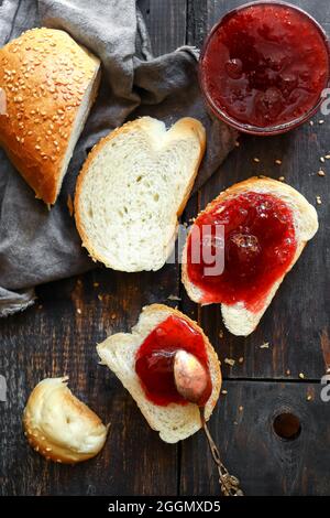 Strawberry jam. Sweet breakfast. Toast with raspberry jam and sliced croissant. Stock Photo