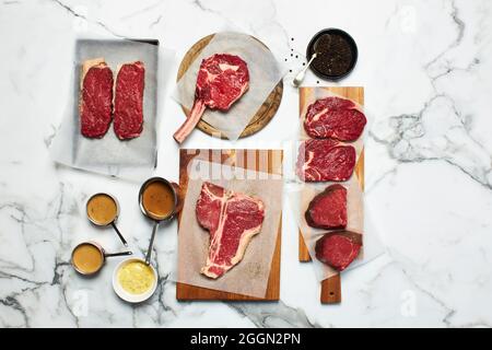 Various cuts of meat on a marble background Stock Photo