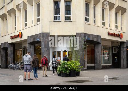 Riga, Latvia. August 2021. some people lined up in front of a bank in the historic center of the city Stock Photo
