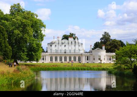 Frogmore House, Frogmore Estate, Windsor, Berkshire, UK with reflections of the blue sky and white fluffy clouds in the lake in summer Stock Photo