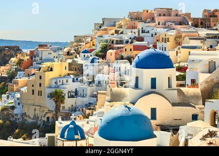 View of Oia town and buildings with typical blue domed churches, Santorini, a Mediterranean Greek Island in the Cyclades group in the Aegean Sea Stock Photo