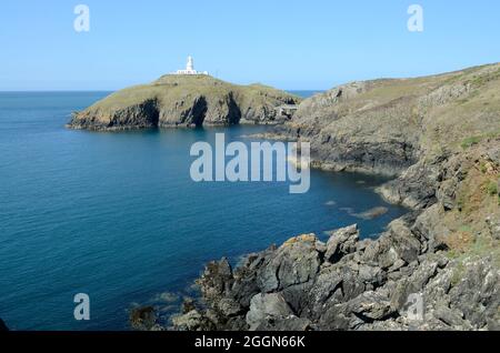 Strumble Head Lighthouse standing on Ynys Meicel Pencaer Peninsula from the Pembrokeshire Coast path Wales Cymru UK Stock Photo