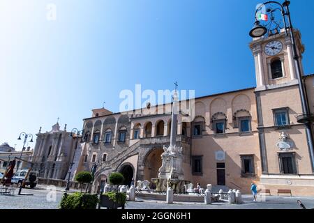 Fountain and town hall in the square of Tarquinia Stock Photo