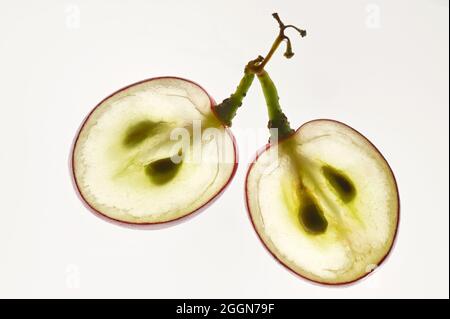 Closeup Translucent Slice Of Red Grape With Seeds In A Cut Stock Photo