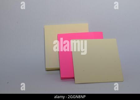 Rectangular sticky notepad. Fuchsia pink and yellow colors on white background Stock Photo