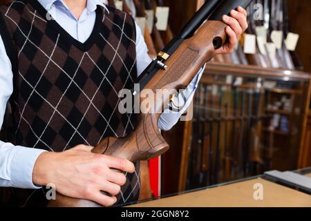 Closeup of sporting air PCP pump-action rifle in male hands Stock Photo