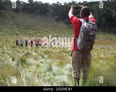 MOUNT KILIMANJARO, TANZANIA - Sep 21, 2016: Tourists climbing Mt Kilimanjaro in Tanzania with local tour guides. Travel shots of people hiking Kiliman Stock Photo