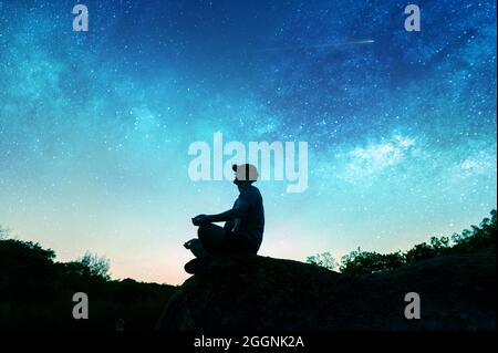 Yoga cosmic space meditation illustration, silhouette of man practicing  outdoors at night Stock Photo - Alamy