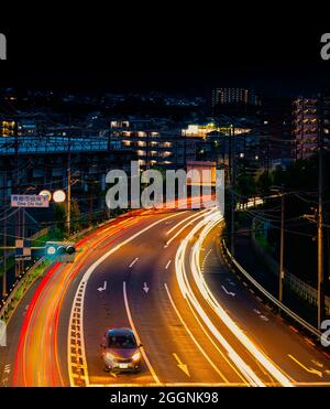 light trails on the street at dusk in Japan Tokyo Stock Photo